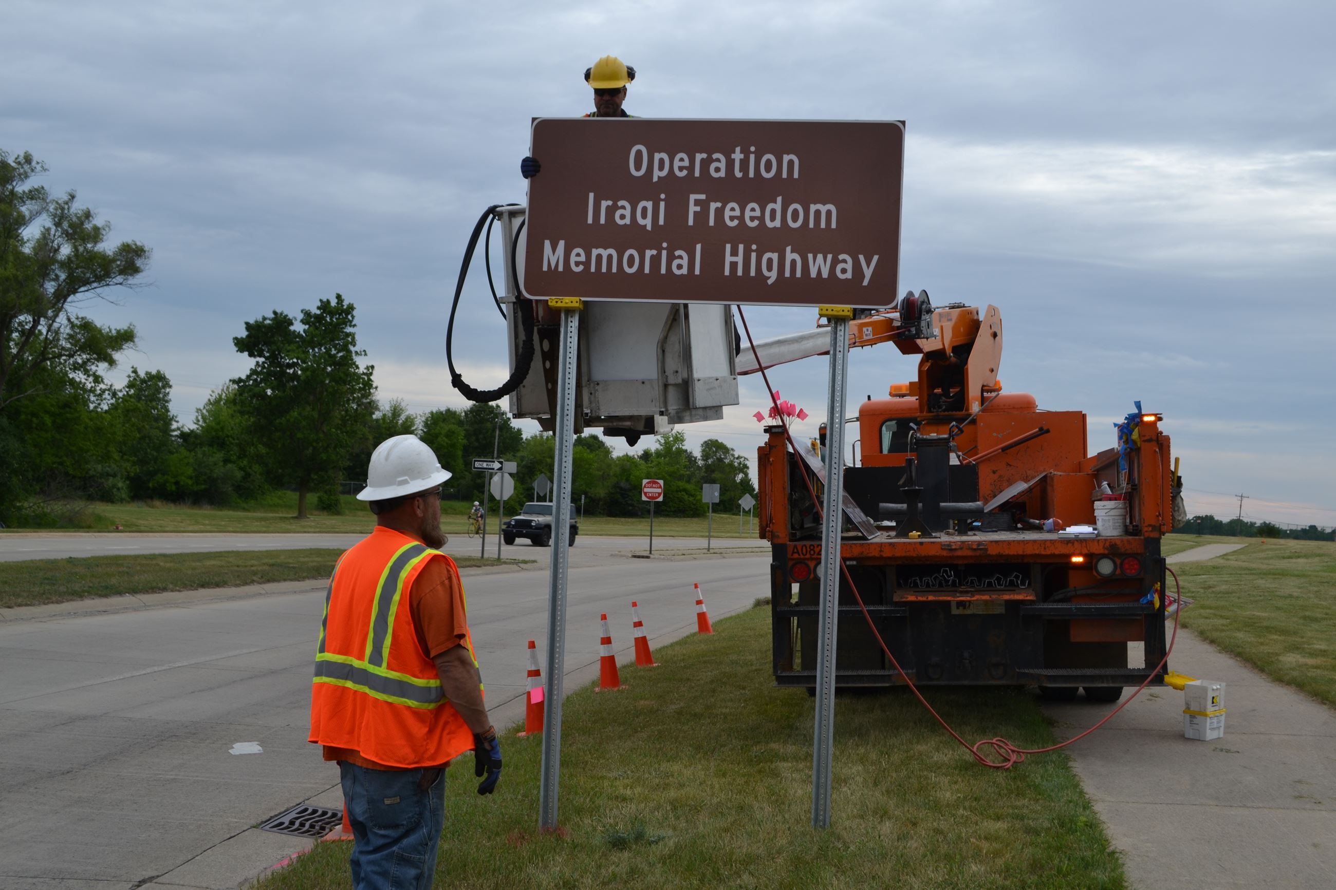 RCOC employees install Operation Iraqi Freedom Memorial Hwy sign on Williams Lake Road north of M-59