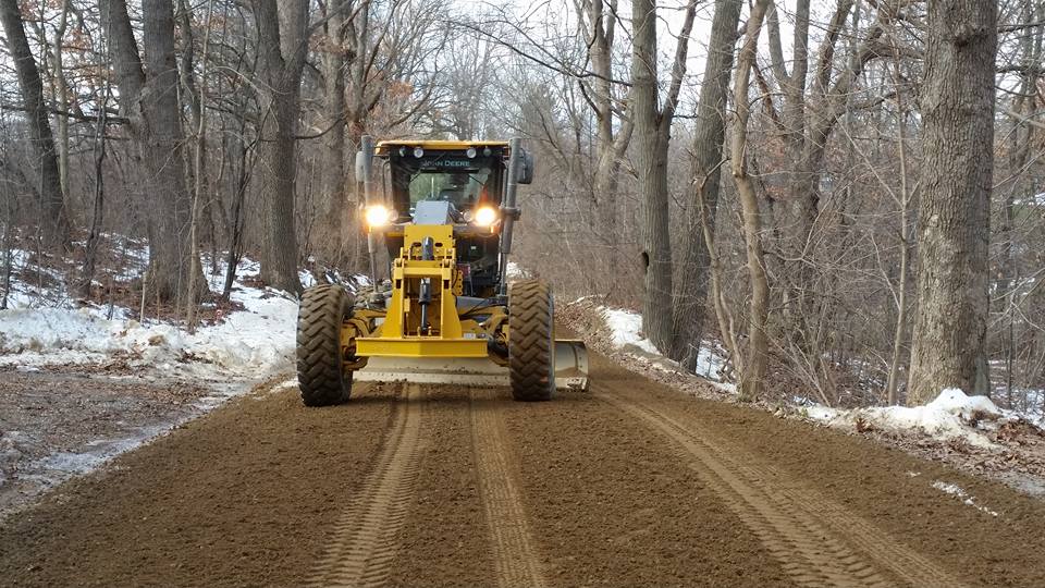 Gravel road grader doing maintenance